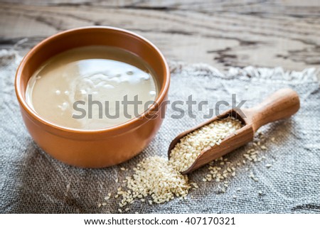 Bowl of tahini with sesame seeds Royalty-Free Stock Photo #407170321