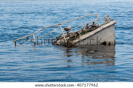 Rusty boat wreck in a blue river Royalty-Free Stock Photo #407177962