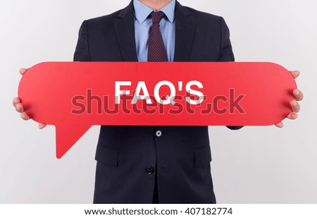 Businessman holding speech bubble with a word FAQ'S