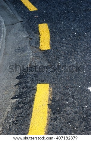 Yellow marks on the side of the road
