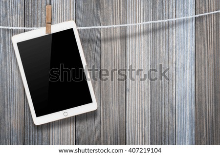 Hanging blank digital tablet computer with isolated screen with clipping path.
