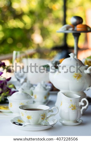 Afternoon tea ceremony, beach restaurant with sea view, flowers orchids, sweets, fruits, different deserts