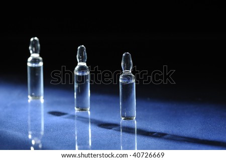 medical ampoules  with solution on blue background