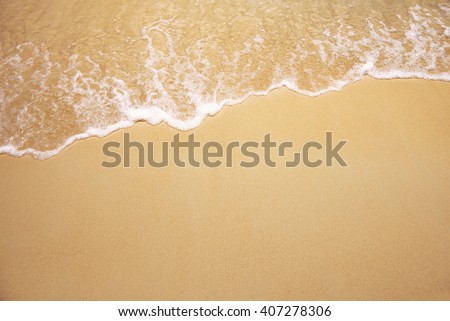 Soft wave of the sea on the sandy beach Royalty-Free Stock Photo #407278306
