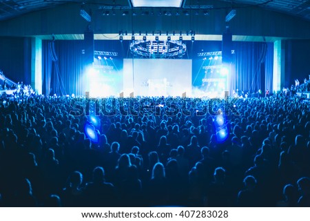 Large concert hall filled with spectators before the stage. Royalty-Free Stock Photo #407283028