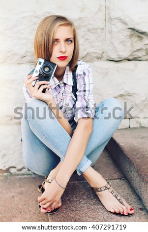 hipster photographer making photo using retro camera. portrait of female photographer