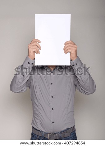 man with a white cardboard hiding his face and copy space for text