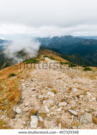 Tatra mountains in Slovakia covered with clouds. autumn colors.