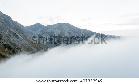 Tatra mountains in Slovakia covered with clouds. autumn colors.
