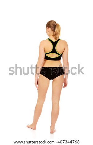 Back view of young athletic woman in sports underwear