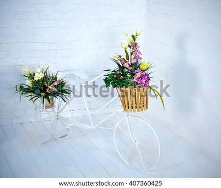 retro bicycle with flowers in Cart on a light background