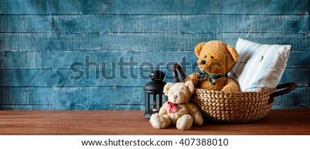 Cute teddy bear in a basket on a wooden table