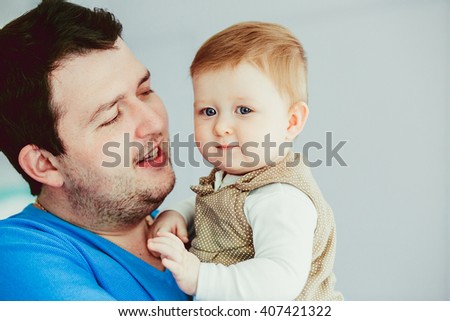 Dad is holding his cute son