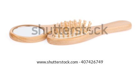 mirror in wooden frame and comb isolated on white background