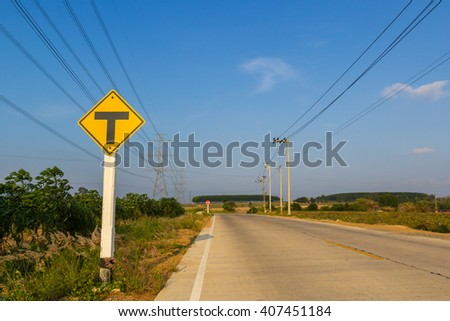 traffic sign post in rural road under blue sky