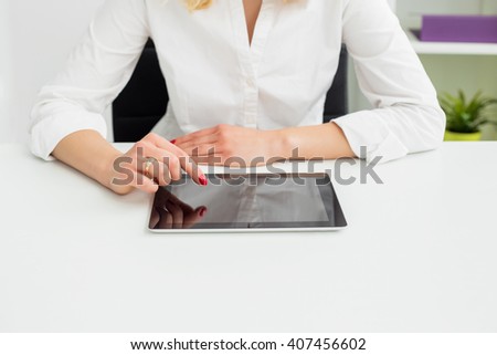 Woman in office using tablet