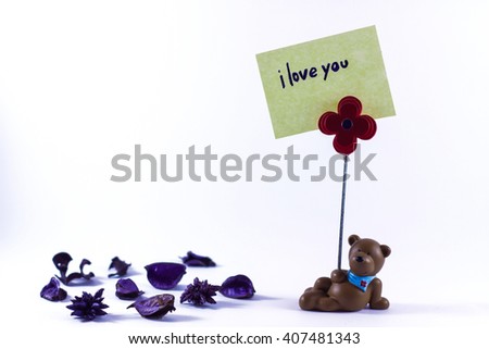Teddy bear with a I Love You sign in a white background