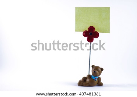 Teddy bear with a blank sign in a white background