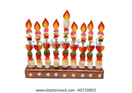 Hanukah menorah made from candies with paper flames isolated on white