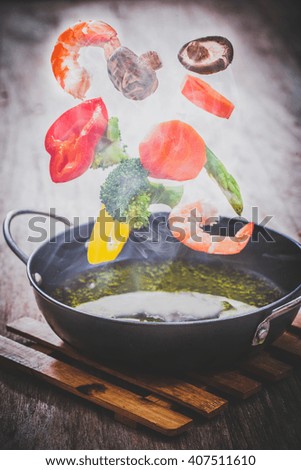 Pan with vegetables in freeze motion