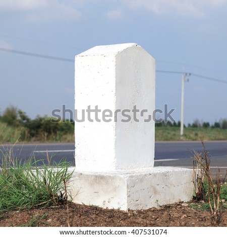 Rectangular columns made of cement embroidery on each side of a one kilometer distance on the road in the country
