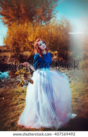 The red-haired girl on the background of the mystical nature
