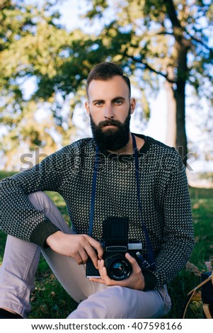 man photographer is making landscape photography with old film camera medium format