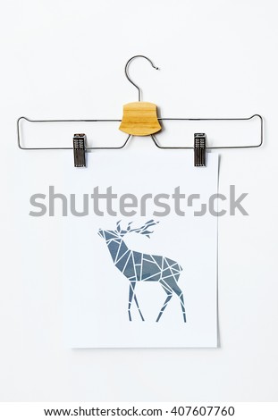 Hanger with geometric deer poster. Scandinavian hipster interior design. 