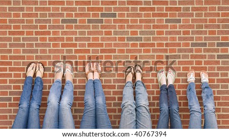 Group of College Girls at School With Legs up on Wall