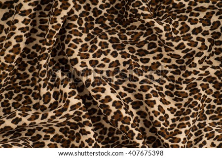 Fabric knitted with a pattern leopard. Texture, background