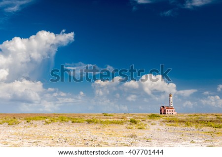 Lonely lighthouse at the desertic Klein Curacao island, close to Curacao, Netherland Antilles Royalty-Free Stock Photo #407701444