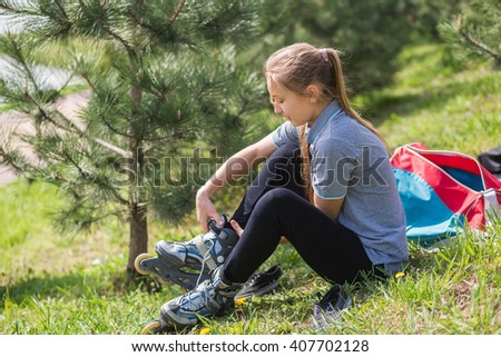 Close-up Of  Young Girl Legs Wearing Roller Skating Shoe, Outdoors