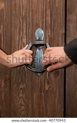 Close up of just married hands opening the door together