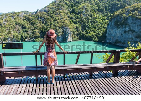 Young women standing at top on of mountain Angthong Islands 