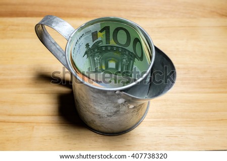 Euro money banknotes in galvanized watering cylinder.