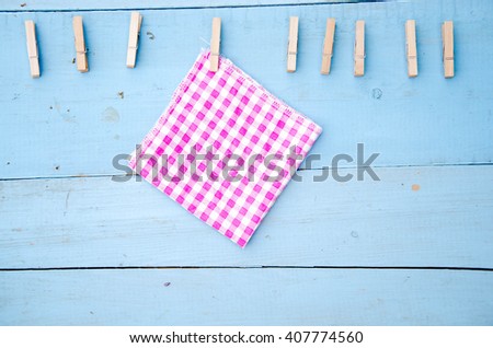 old photo and clothes peg on a wooden background