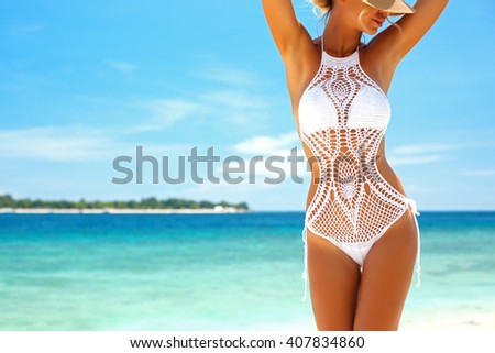 Beautiful woman wearing crochet bikini posing over the sea view, beach lifestyle