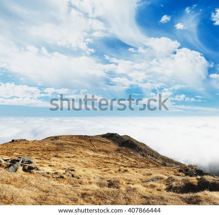 A great view of the foggy hills and cloudy sky which glowing by sunlight. Dramatic and picturesque morning scene. Location place: Carpathian, Ukraine, Europe. Artistic picture. Beauty world. 
