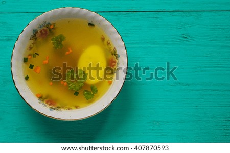 clear soup with vegetables in plate on wooden table .Rustic style.Top view. Free space for text.