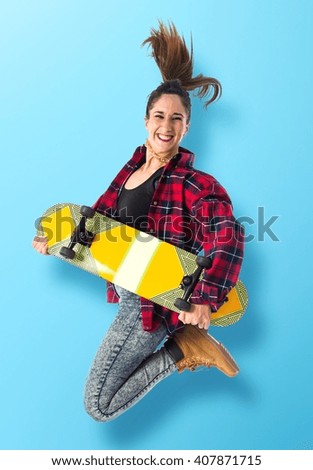 Happy woman jumping with skate