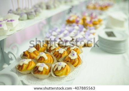 eclairs with icing on dessert table