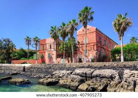 Street with old red houses at the coast of Goree island, Dakar, Senegal Royalty-Free Stock Photo #407905273