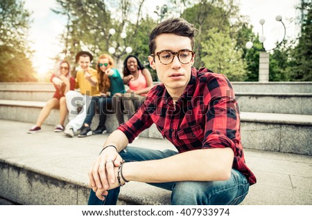 Boy being bullied in school - Young students making fun of a young boy at high school Royalty-Free Stock Photo #407933974