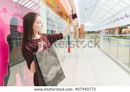 Girl taking a photo with her purchases