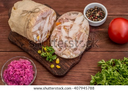 Aspic with meat and horseradish on a wooden table 