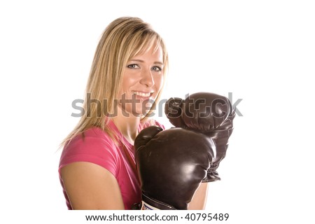 A woman wearing boxing gloves, getting ready to box.