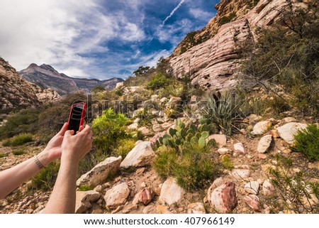 Woman hands with smartphone taking picture of beautiful landscape