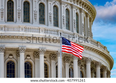 Washington DC Capitol dome detail with waving americanstar and stripes flag Royalty-Free Stock Photo #407995261