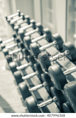 Dumbbell in modern luxury fitness center abstract blur background
