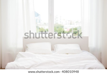 rest, interior, comfort and bedding concept - bed at home bedroom Royalty-Free Stock Photo #408010948